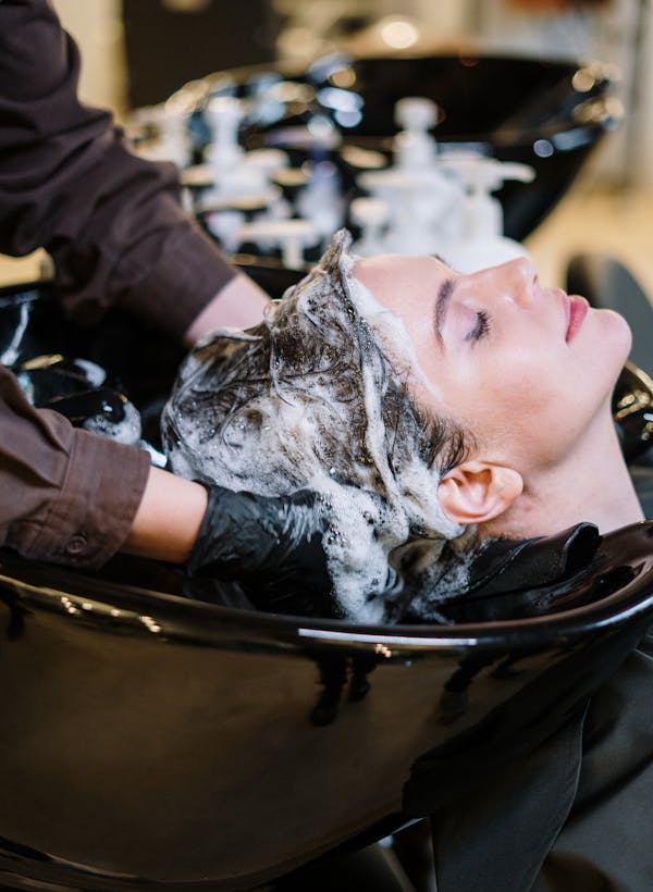 Salon receptionist checking the appointment schedule on a desktop computer